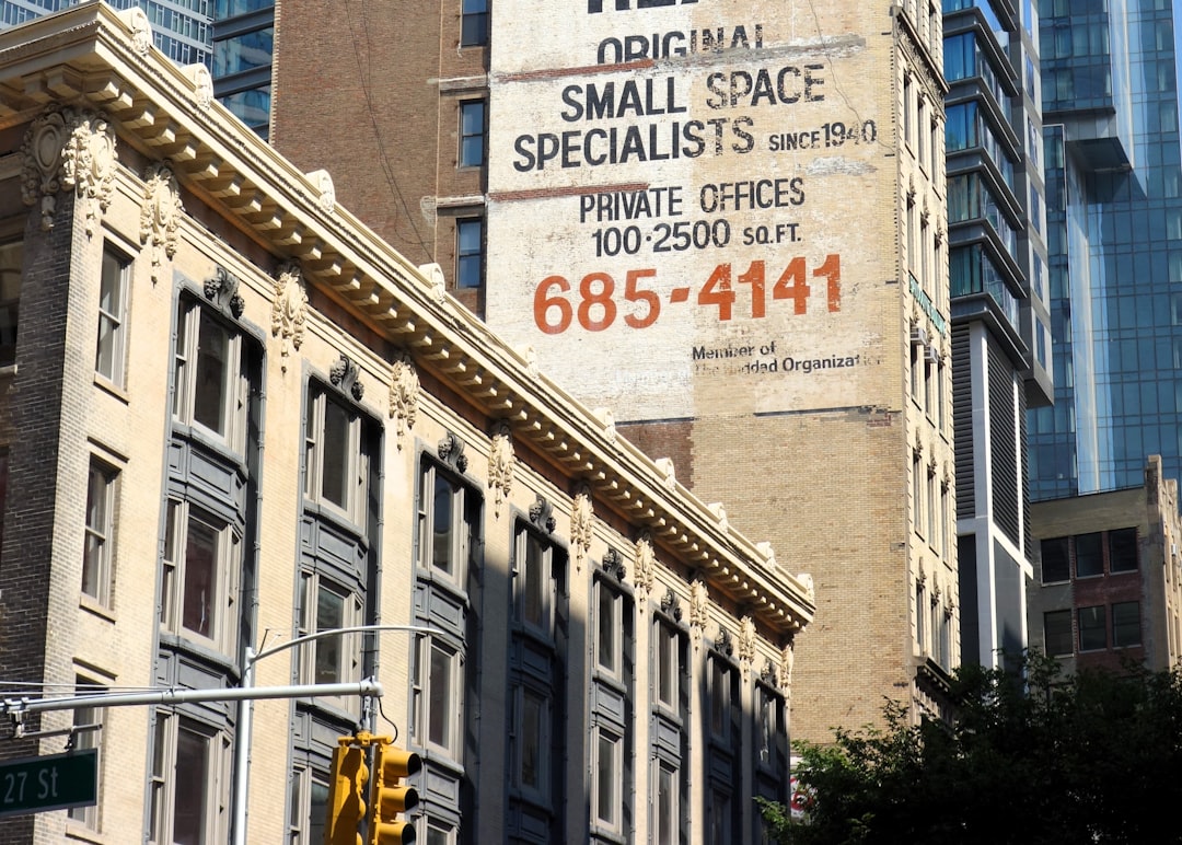 a sign on the side of a building in a city
