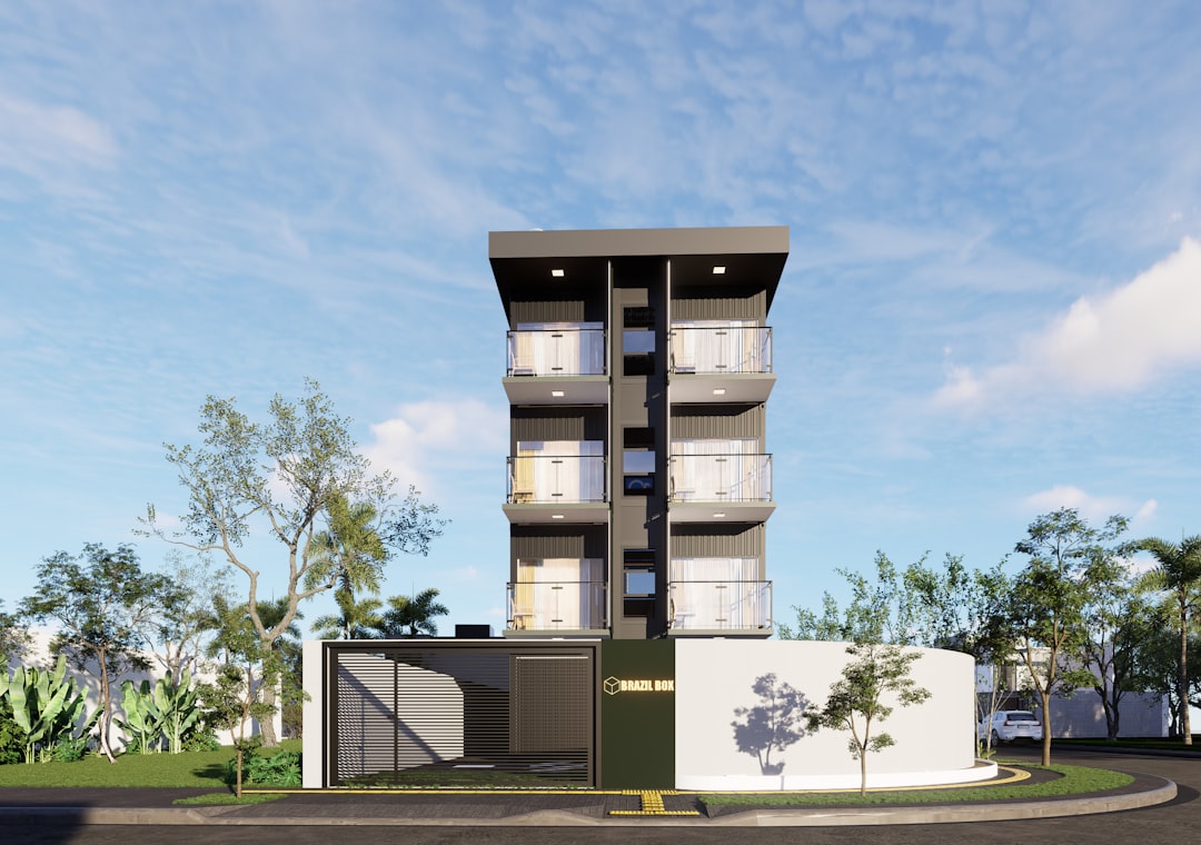 Modern apartment building with balconies and fence.